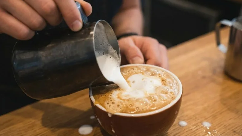 Example of failed latte art due to poor foam quality showing large bubbles and messy appearance